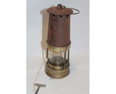 An old brass mounted steel miner's lamp with key 