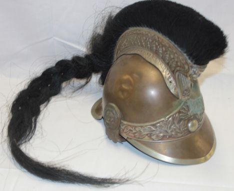 A 19th Century French Gendarmerie mounted officers steel helmet with raised comb and horse hair trim, lions mask bosses and f