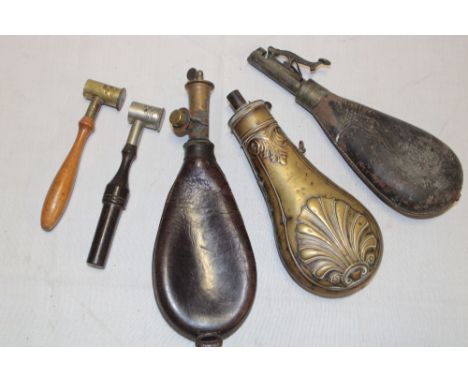 A 19th century brass powder flask with acanthus decoration, two 19th century leather shot bags and two powder measures (5) 