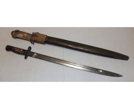 A Second War Lee Enfield bayonet with single edged blade in leather scabbard with webbing frog, the hilt stamped "R.E. 23 Coy