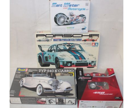 A Tamiya 1:20 scale Martini Porsche 935 model kit, Revell 1:24 Mercedes- Benz Cabrio model kit and two others (4)