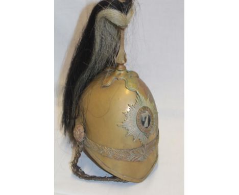 A Cavalry Trooper's brass helmet of the 7th Dragoon Guards with horse hair plume, bi-metal star badge, leather liner and chin