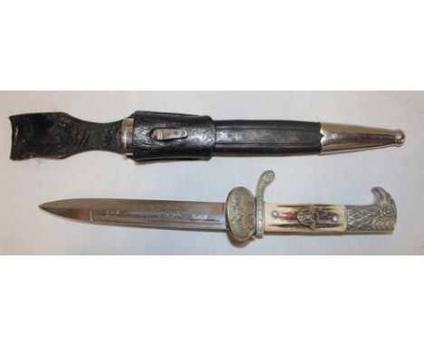 A Second War German Police bayonet with 8" single edged blade engraved "In Schutz  Polizei", oval guard with raised eagle emb