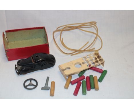 A Schuco 3000 clockwork sedan car with accessories and part box 