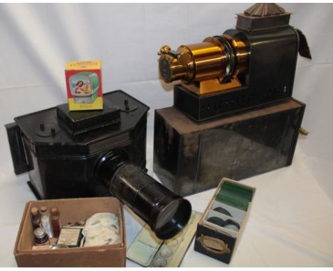 An unusual Mirrorscope model 1912 magic lantern slide projector  with various glass slides, binding outfit, 7 inch brass lens