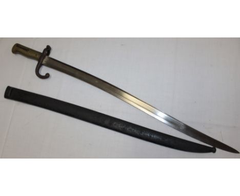 A French Chassepot bayonet with single edged blade marked "De Chat 1868" in steel scabbard.