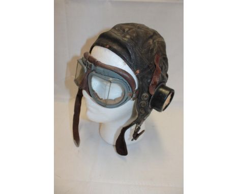 A Second War RAF brown leather flying helmet with accompanying goggles 