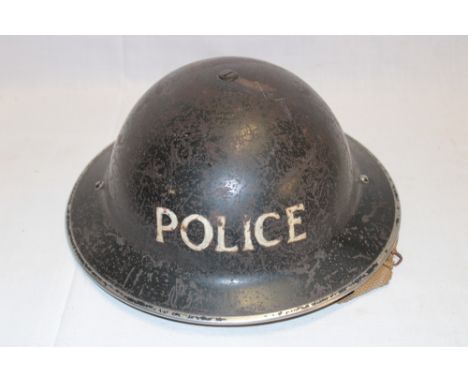 A Second War Home Service steel helmet with painted "POLICE" insignia