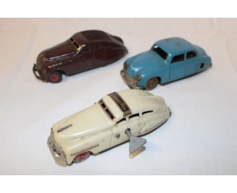 A Schuco Fex 1111 clockwork tin plate sedan car, Schuco Commando 2000 tin plate car and one other (3)