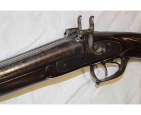 A 19th century percussion double barrelled sporting gun with 31" Damascus barrels, plain steel locks and Continental carved w