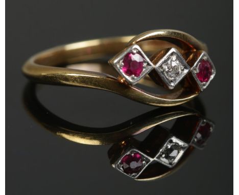 An 18ct gold and platinum, diamond and ruby three stone ring. Makers mark for AW Crosbee &amp; Sons Ltd. Size U. 4.65g.  