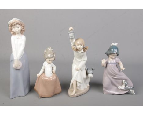 Four Nao by Lladro ceramic figures each depicting young girls, two with dogs.  