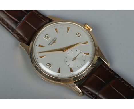 A gents 9ct gold Longines manual wristwatch. Having subsidiary seconds and baton and Arabic numeral markers.  Running.