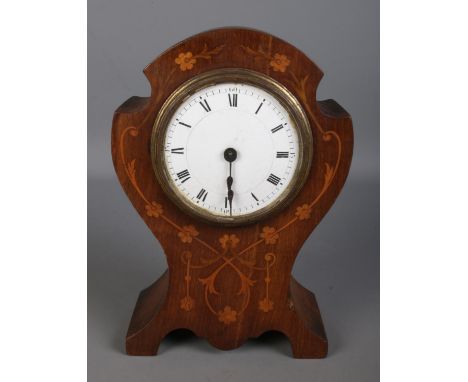 A mahogany inlaid balloon mantle clock featuring enamel face, roman numeral dial and floral decoration.  Glass is missing and