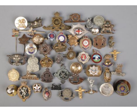 A collection of mainly military pin badges, buttons and stick pins.  
