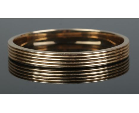 A 10ct gold bangle. 12.85g. Bangle opening 6cm.  