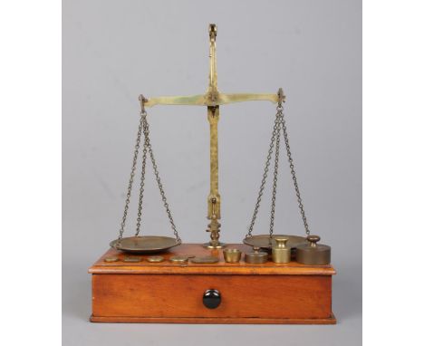 A boxed set of Victorian brass bankers scales, by J. Hare, Birmingham, together with an assortment of weights, including Aver