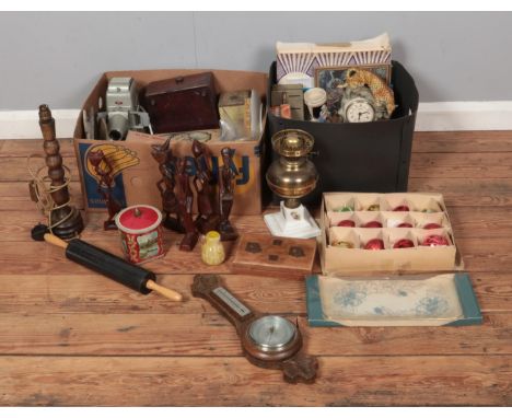 Two boxes of miscellaneous to include vintage tins, carved figures, art glass, costume jewellery, Aldis projector, Quartz leo