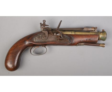 A flintlock pistol with flick over knife to top of barrel. Total length 28cm. CANNOT POST.  We can pack this item and the buy