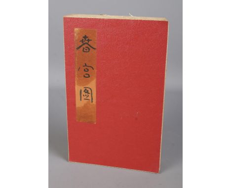 A Japanese Shunga fold out book with central panel depicting couple playing Go and flanked by erotic scenes.  
