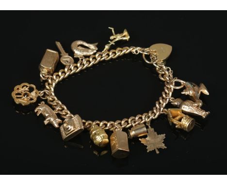 A 9ct gold charm bracelet with mostly 9ct gold charms. Gross weight 36.54g.  