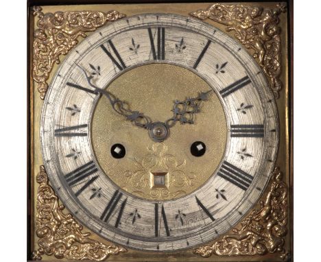 A Georgian mahogany longcase clock. Having twin swan neck pediments, carved lion detail and satinwood strung inlaid decoratio