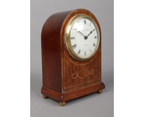A small Edwardian brass inlaid mahogany dome top mantel clock. The dial marked for Edmond Johnson Ltd, Dublin and having Roma
