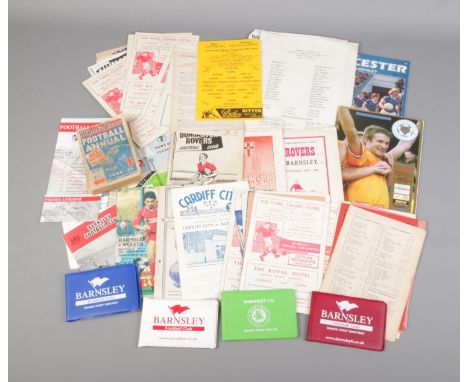 A box of Barnsley Football programmes and ephemera to include 1980's season ticket books, newspaper clippings, travel ticket,