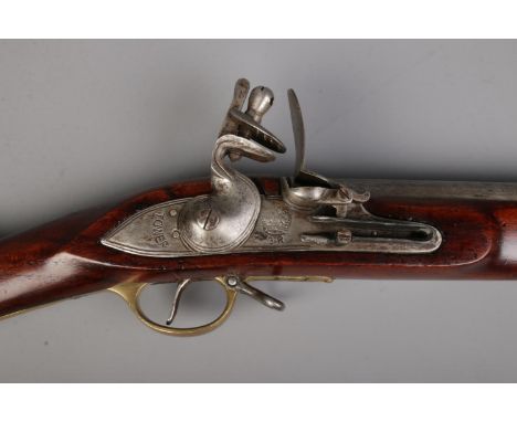 A 19th century flint lock Brown Bess musket. Stamped Tower to lock plate and stock, along with crowned GR cypher. Stock also 