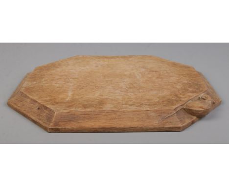 Robert 'Mouseman' Thompson, an oak cheese board with signature mouse carving. 31cm x 26cm.  