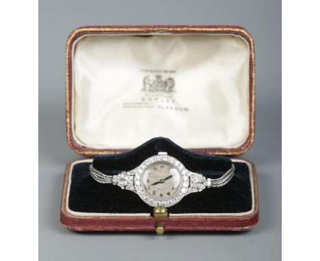 A vintage ladies platinum and diamond manual cocktail watch on 9ct white gold rope twist strap. 19.81g.  Running.