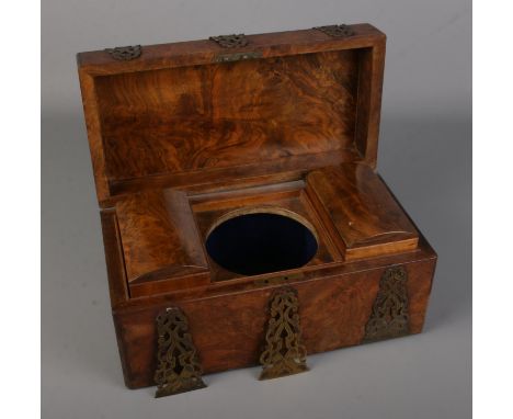 A Victorian rectangular burr walnut tea caddy with brass mounts and escutcheons.  No central bowl and some exterior brass mou
