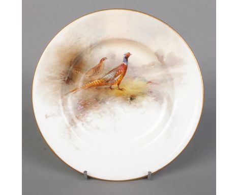 James Stinton for Royal Worcester, a porcelain plate with hand painted scene depicting male and female pheasants in landscape