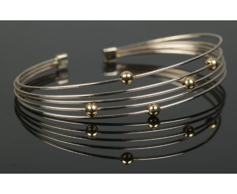 A 9ct white and yellow gold five band bangle. 7.58g.  