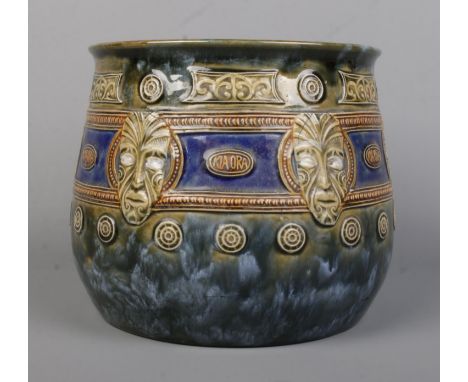 An early 20th century Royal Doulton Maori Ware glazed stoneware jardiniere. Decorated with mask and inscribed Kia Ora. Height