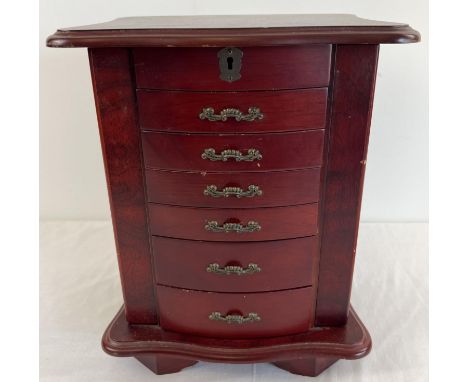 A vintage wooden chest style jewellery box. 6 front opening drawers with small square compartments to top two drawers. Two si