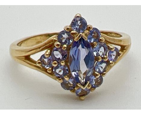 A 9ct gold and Iolite stone set dress ring. A central marquise cut Iolite stone surrounded by 12 round cut Iolites. Full hall