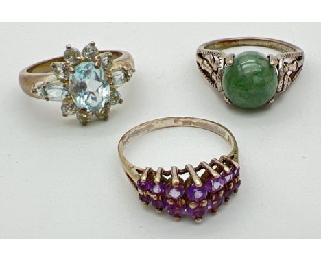 3 silver stone set dress/cocktail rings. A cathedral style ring set with 12 round cat graduating size amethysts; a moss green