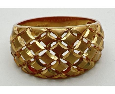 A 9ct gold dome style dress ring with pierced work lattice design to top. Full hallmarks to inside of band. Size S, total wei