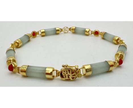 A 7.5 inch 14k gold, green and orange jade bracelet. 8 small barrel beads of green jade with alternating small orange jade ca