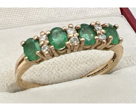 A 9ct gold emerald and diamond set half eternity ring. 4 round cut emeralds with 2 small round cut diamonds between each. Eme