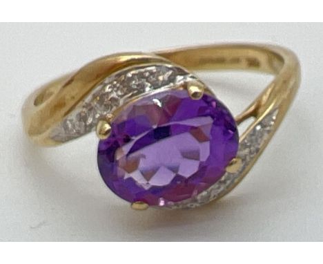 A 9ct gold amethyst and diamond ring with twist design mount. A central oval cut amethyst with 5 small round cut diamonds to 