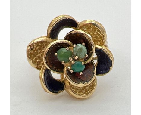 A vintage 18ct gold bespoke made dress ring in the shape of a flower with 3 midnight blue enameled petals and set with 3 smal