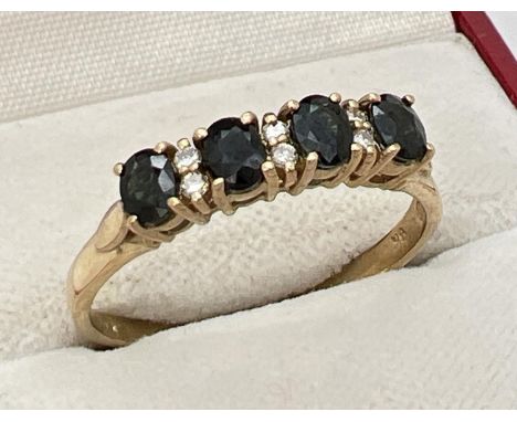 A 9ct gold sapphire and diamond half eternity ring. Set with 4 round cut dark sapphires and 6 small round cut diamonds. Fully