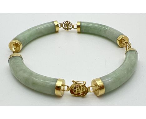 A 14ct gold and pale green jade bracelet. Long curved jade beads with capped ends and alternating gold pierced work small rou