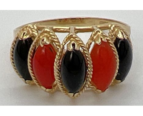 A 14K gold cathedral style dress ring set with marquise cut black onyx and carnelian stones. Gold marks to inside of band (wo