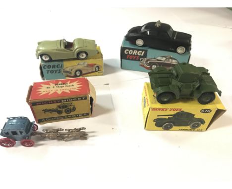 A Corgi toys Triumph T.R.3 Sports car#305, a corgi toys Riley Pathfinder police car#209,a Dinky toys Armoured car#670 and a m