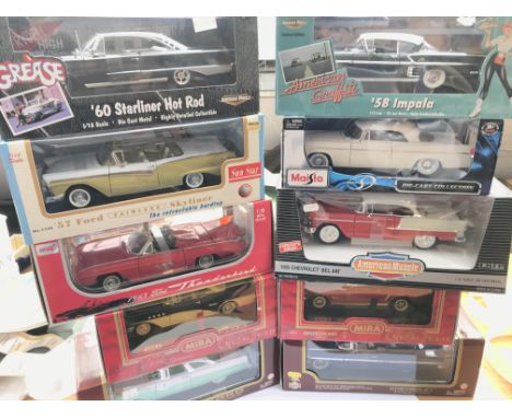 A collection of 1:18 scale cars, all boxed including cars from movies Grease and American Graffiti.