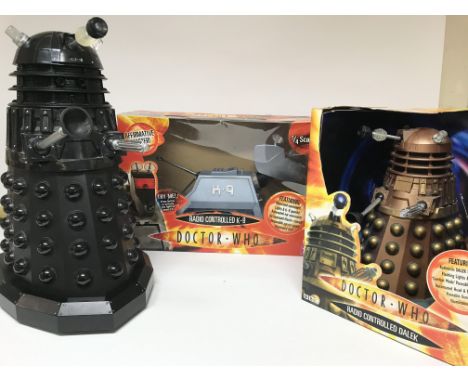 A remote controlled k-9, a remote controlled Dalek (boxed) and another Dalek. (3)