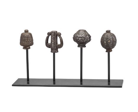 FOUR DETACHED RAPIER POMMELS, FIRST QUARTER OF THE 17TH CENTURY the first plummet-shaped, with vertical flutes, and encrusted